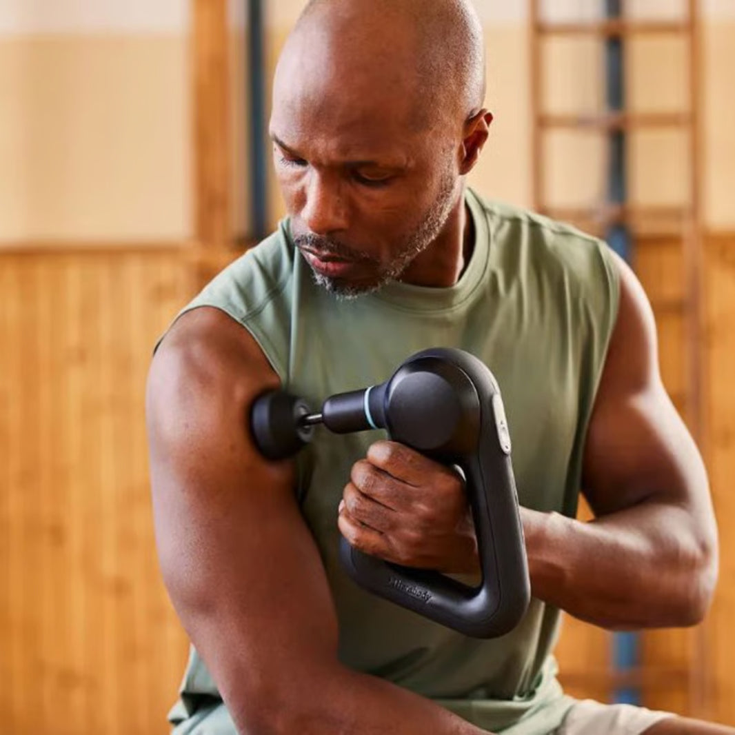 Man exercising with a dumbbell in a gym setting